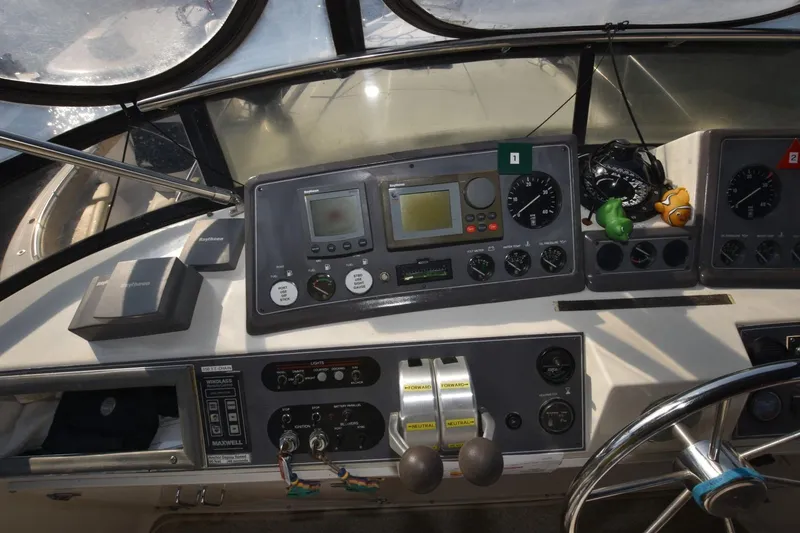 Slide: The Image of 1990 Californian 45 Motor Yacht helm with navigation instruments and steering wheel. - 55