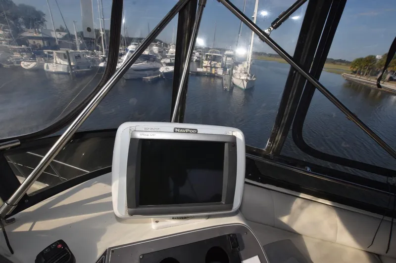 Slide: The Image of Cockpit view from 1990 Californian 45 Motor Yacht, featuring navigation equipment and marina. - 58
