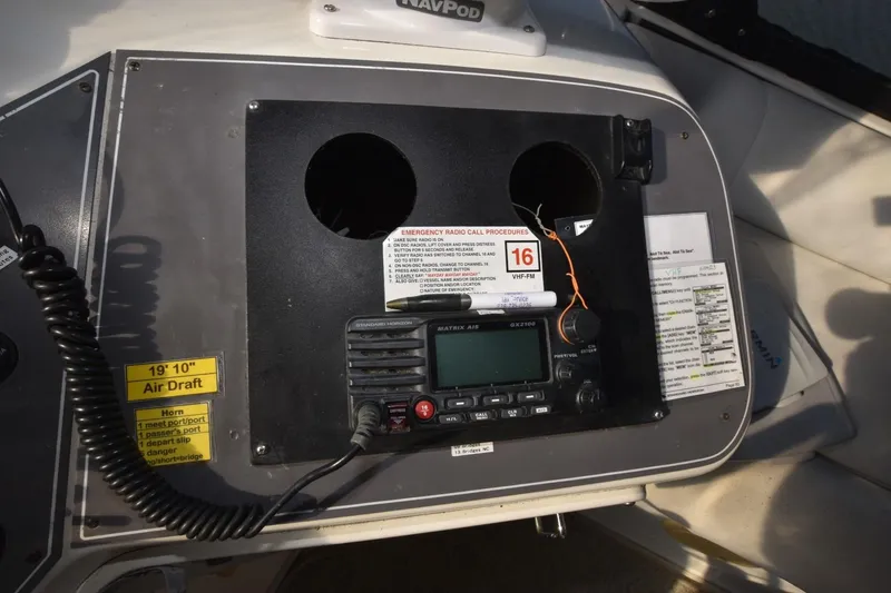 Slide: The Image of Control panel of a 1990 Californian 45 Motor Yacht with radio and emergency procedures. - 59