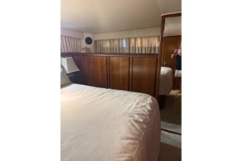 Slide: The Image of 1990 Californian 45 Motor Yacht bedroom with wood paneling and cozy bedding. - 6