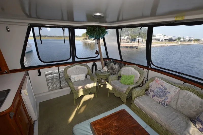 Slide: The Image of Interior of 1990 Californian 45 Motor Yacht with wicker furniture and scenic water view. - 63