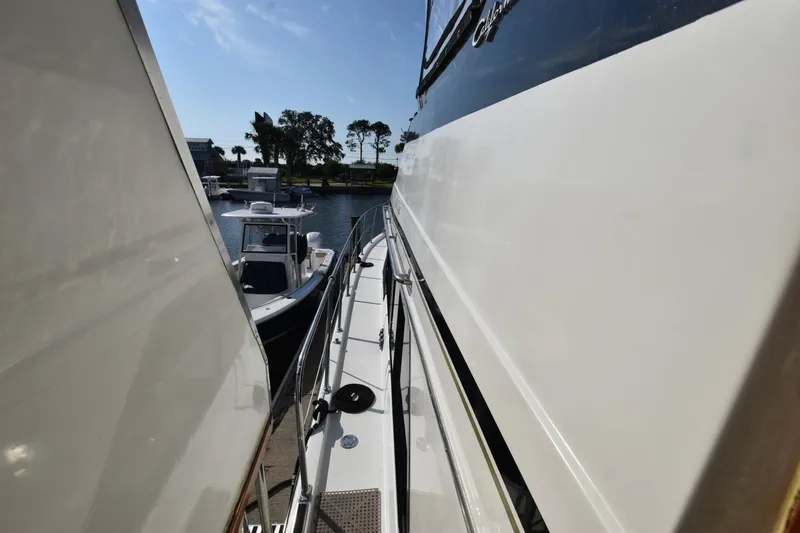 Slide: The Image of Side view of a 1990 Californian 45 Motor Yacht docked at a marina. - 66
