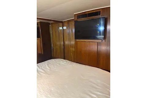 Slide: The Image of Interior of 1990 Californian 45 Motor Yacht with wood paneling and mounted TV. - 7