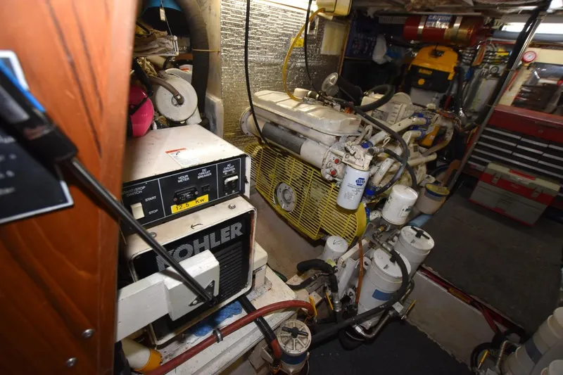 Slide: The Image of Engine room of 1990 Californian 45 Motor Yacht with Kohler generator and mechanical components. - 72