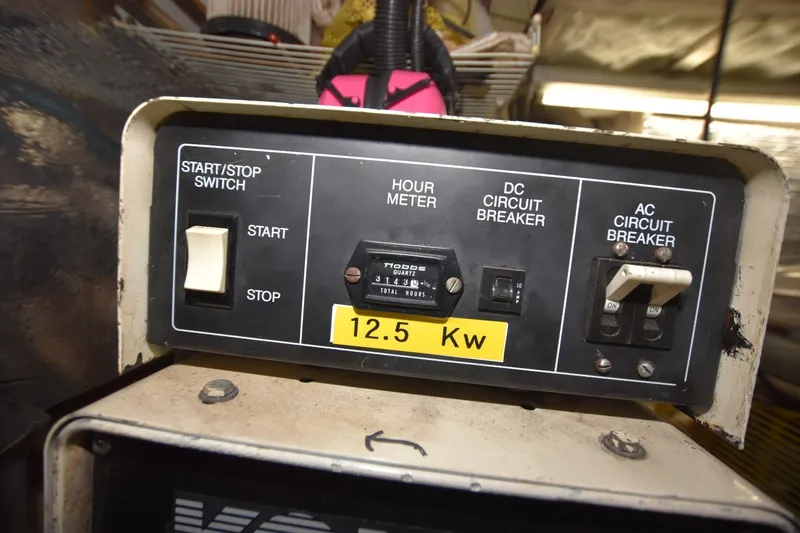Slide: The Image of Control panel of a 1990 Californian 45 Motor Yacht, featuring start/stop switch and circuit breakers. - 73