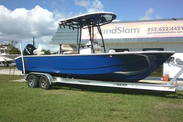 The Image of 2023 Carolina Skiff 26 Ultra Elite boat on trailer, blue hull, outdoor display. - 0