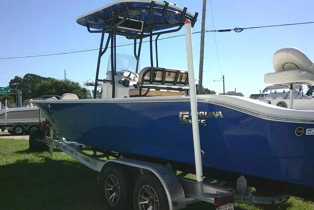 Slide: The Image of 2023 Carolina Skiff 26 Ultra Elite boat on trailer, blue hull, outdoor display. - 13