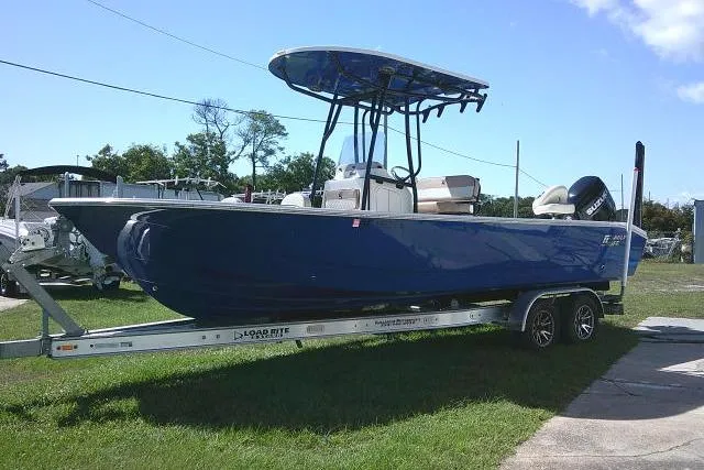 Slide: The Image of 2023 Carolina Skiff 26 Ultra Elite boat on trailer, blue hull, outdoor display. - 15