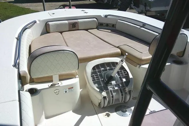 Slide: The Image of 2023 Carolina Skiff 26 Ultra Elite boat interior with cushioned seating and steering console. - 16