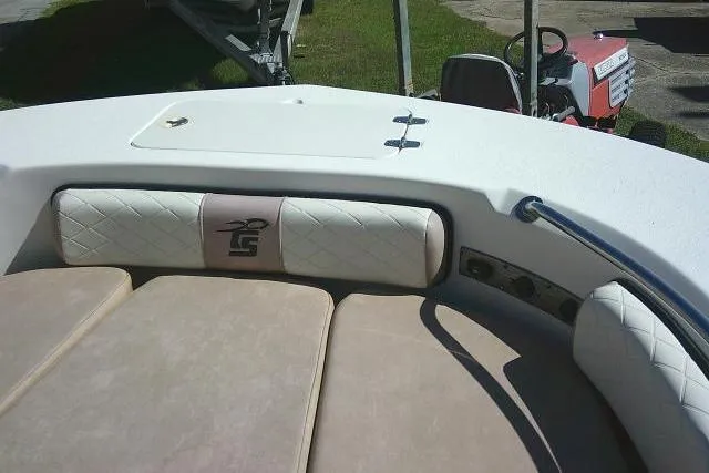 Slide: The Image of 2023 Carolina Skiff 26 Ultra Elite boat interior with cushioned seating and storage compartment. - 19