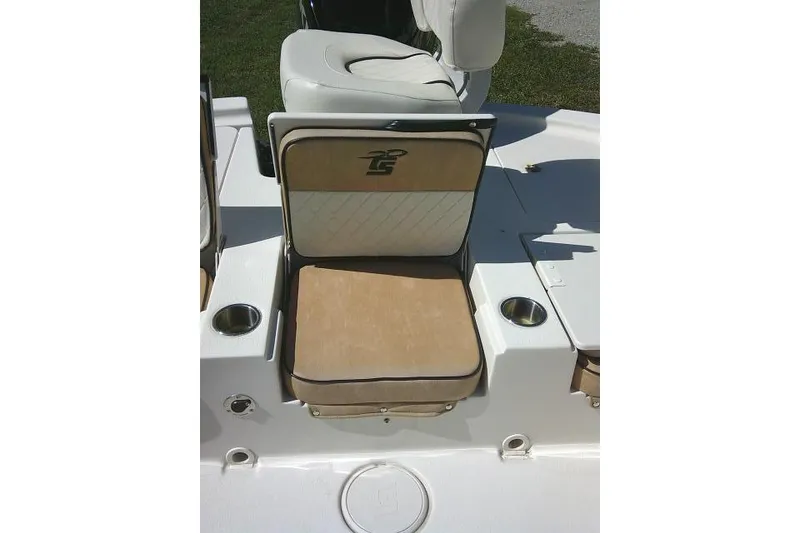 Slide: The Image of 2023 Carolina Skiff 26 Ultra Elite boat seat with cup holders and beige cushions. - 44