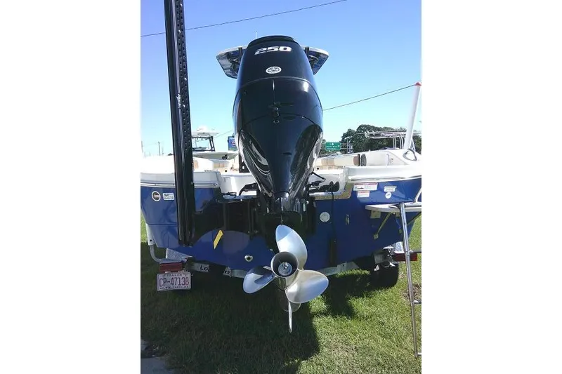 Slide: The Image of 2023 Carolina Skiff 26 Ultra Elite boat with powerful outboard motor, displayed on grass. - 8