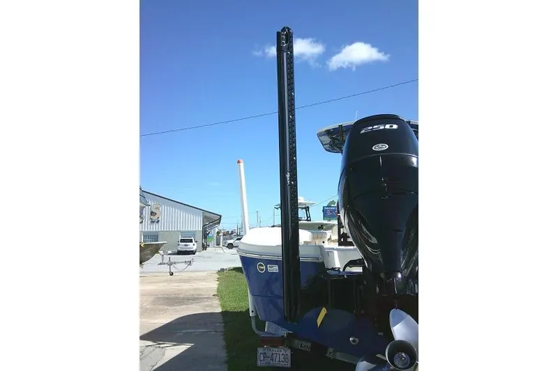 Slide: The Image of 2023 Carolina Skiff 26 Ultra Elite boat with powerful outboard motor, parked outdoors. - 9