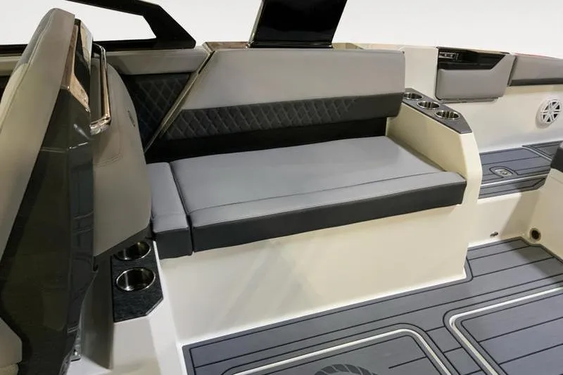 Slide: The Image of 2026 Cobalt R31 boat interior with gray seating, cup holders, and modern design elements. - 14