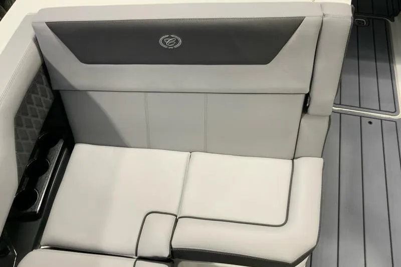 Slide: The Image of 2026 Cobalt R31 boat interior with gray cushioned seating and cup holders. - 16