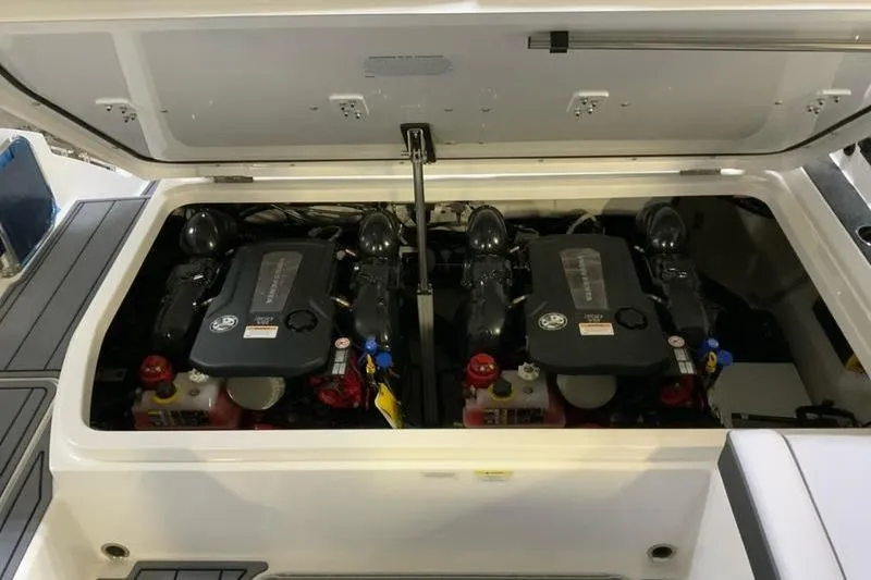 Slide: The Image of 2026 Cobalt R31 boat storage compartment with fire extinguishers and wrapped equipment. - 19