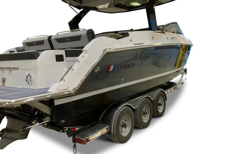 Slide: The Image of 2026 Cobalt R31 boat with American flag, sleek design, and spacious seating. - 3