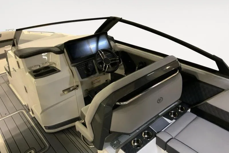 Slide: The Image of 2026 Cobalt R31 boat interior with control panel and American flag. - 9