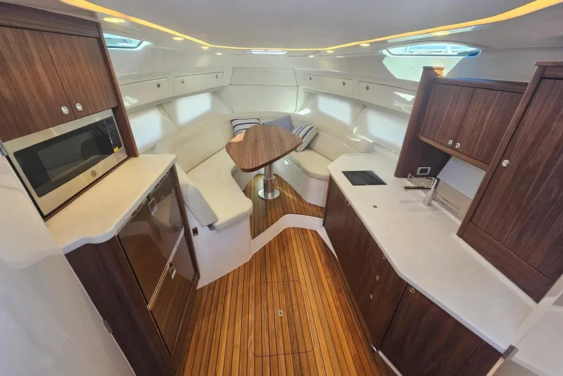 Slide: The Image of Luxurious interior of 2026 Intrepid 438 Evolution yacht with modern kitchen and seating area. - 11