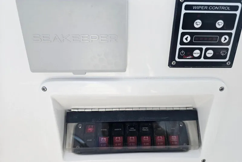 Slide: The Image of Control panel on 2026 Intrepid 438 Evolution boat with Seakeeper and wiper controls. - 16