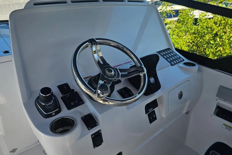 Slide: The Image of Helm of 2026 Intrepid 438 Evolution boat with modern controls and steering wheel. - 7
