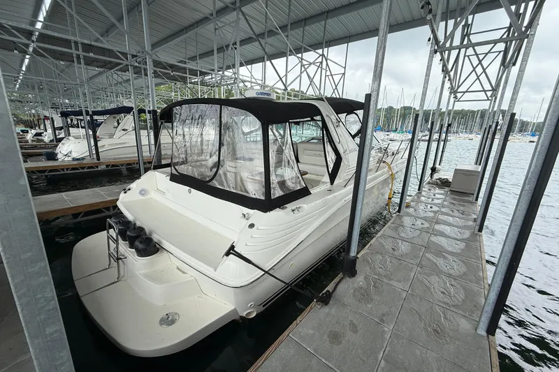 Slide: The Image of 1997 Sea Ray 400 Express Cruiser docked in a covered marina. - 10