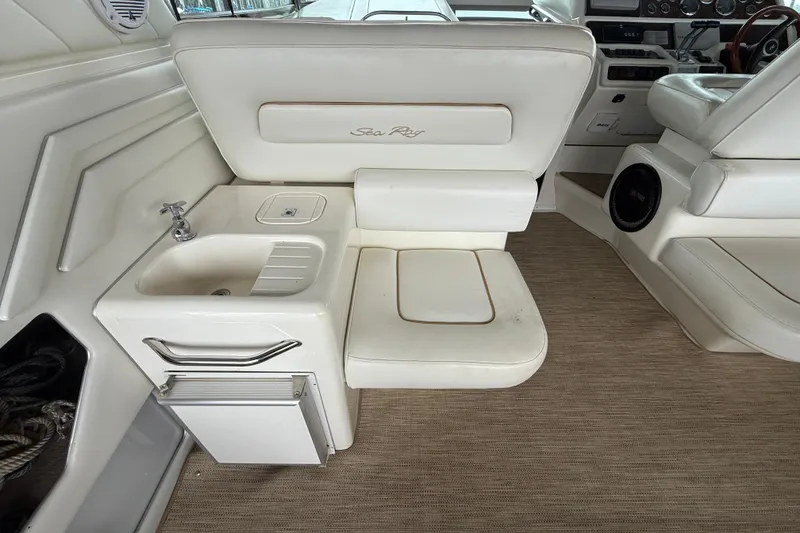 Slide: The Image of 1997 Sea Ray 400 Express Cruiser interior with sink and seating area. - 14