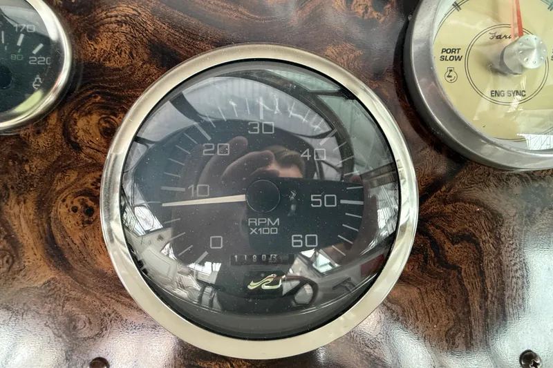 Slide: The Image of 1997 Sea Ray 400 Express Cruiser dashboard with RPM gauge and wood finish. - 17