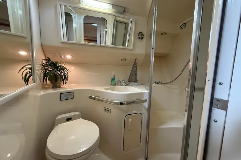 Slide: The Image of Luxurious bathroom in 1997 Sea Ray 400 Express Cruiser with shower and modern amenities. - 19