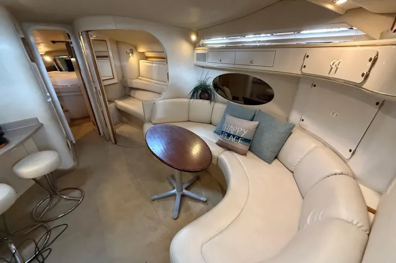 Slide: The Image of Interior of 1997 Sea Ray 400 Express Cruiser with plush seating and cozy decor. - 22