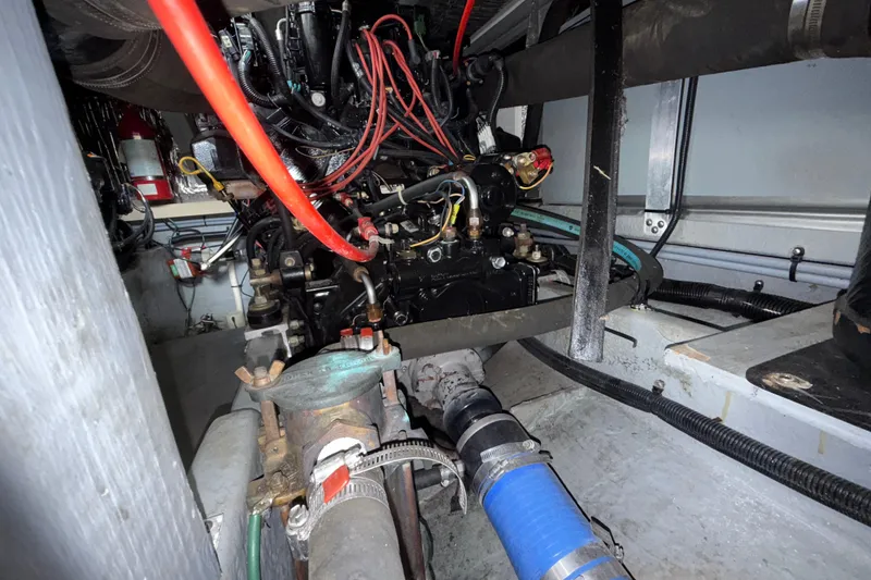 Slide: The Image of Engine compartment of a 1997 Sea Ray 400 Express Cruiser with visible wiring and components. - 3