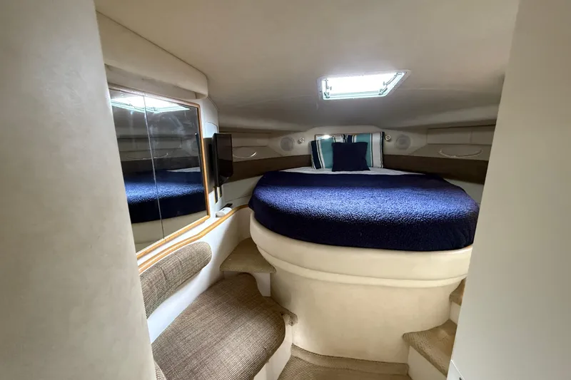 Slide: The Image of Interior cabin of 1997 Sea Ray 400 Express Cruiser with cozy bed and seating. - 30