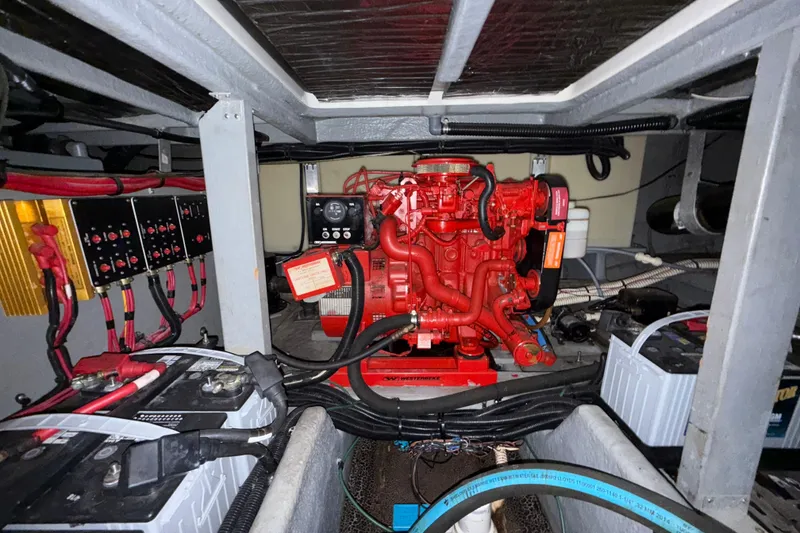 Slide: The Image of Engine room of 1997 Sea Ray 400 Express Cruiser with red engine and electrical components. - 31