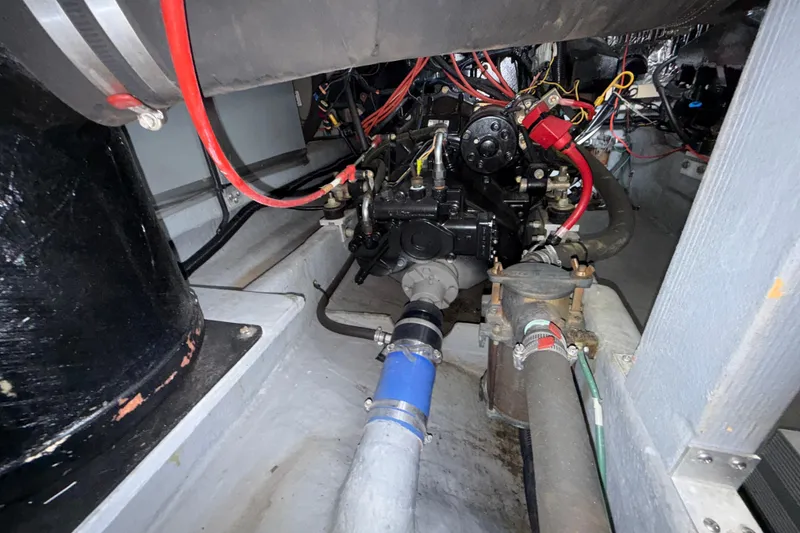 Slide: The Image of Engine compartment of a 1997 Sea Ray 400 Express Cruiser with visible wiring and components. - 5