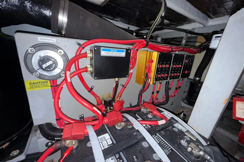 Slide: The Image of Electrical system of a 1997 Sea Ray 400 Express Cruiser with red wiring and control panels. - 9