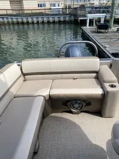 Slide: The Image of 2022 Avalon Catalina Entertainer 24' pontoon boat with beige seating at dock. - 14