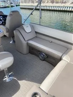 Slide: The Image of 2022 Avalon Catalina Entertainer 24' boat interior with beige seating and lake view. - 15