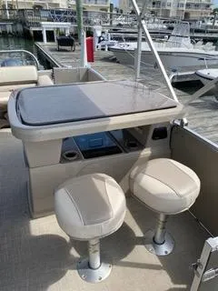 Slide: The Image of 2022 Avalon Catalina Entertainer 24' boat interior with seating and table. - 17