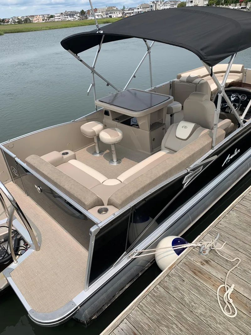 Slide: The Image of 2022 Avalon Catalina Entertainer 24' pontoon boat docked by the water. - 3