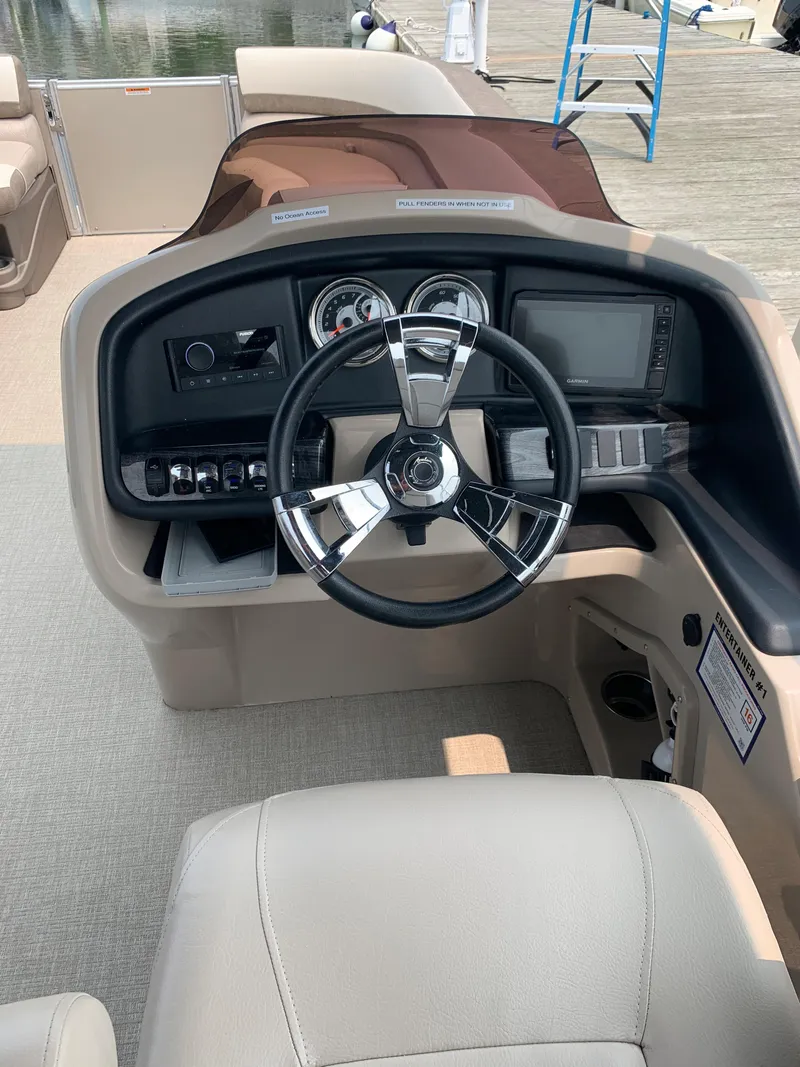 Slide: The Image of 2022 Avalon Catalina Entertainer boat dashboard with steering wheel and controls. - 4