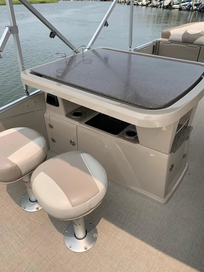 Slide: The Image of 2022 Avalon Catalina Entertainer boat interior with table and seating. - 5