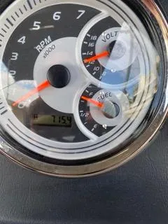 Slide: The Image of Close-up of 2022 Avalon Catalina Entertainer gauge showing RPM, voltage, and fuel levels. - 7