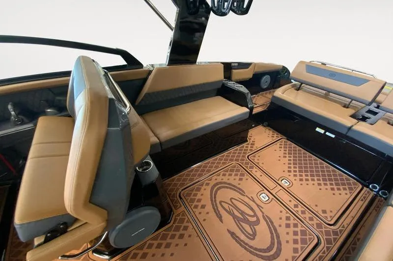Slide: The Image of Interior of 2026 Cobalt R31 Surf boat with tan and black seating. - 14