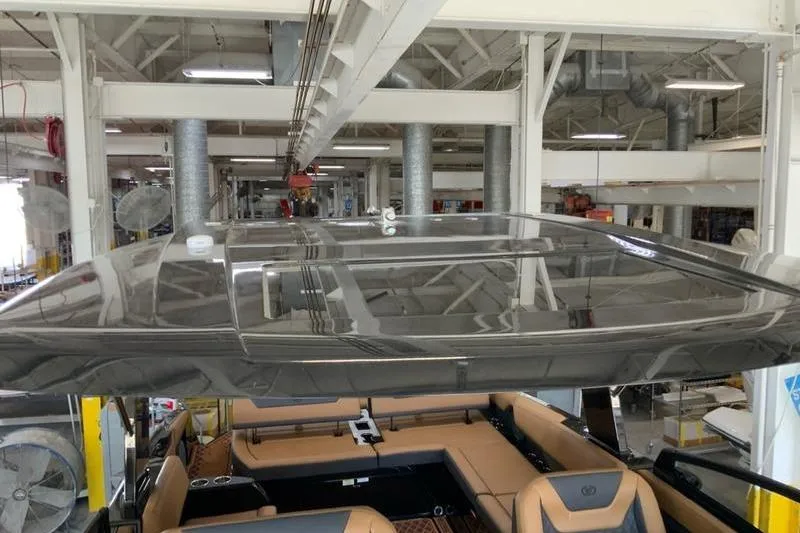 Slide: The Image of 2026 Cobalt R31 Surf boat interior in a factory setting, showcasing luxury seating. - 16