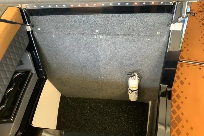 Slide: The Image of 2026 Cobalt R31 Surf storage compartment with fire extinguisher, featuring sleek interior design. - 18