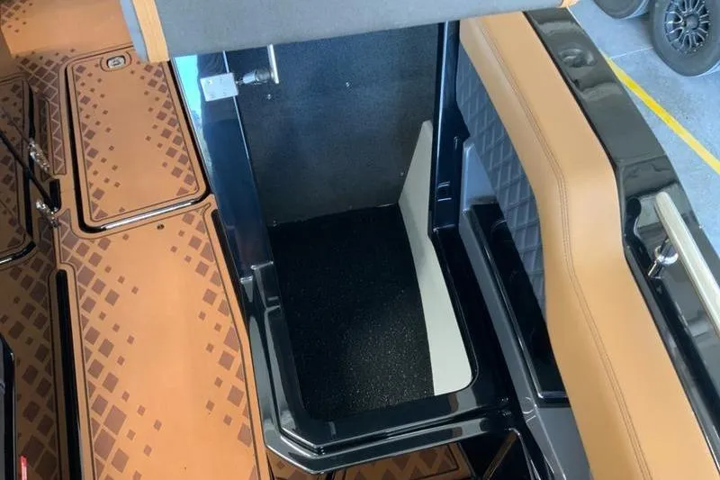 Slide: The Image of Interior view of 2026 Cobalt R31 Surf boat with tan and black seating. - 19