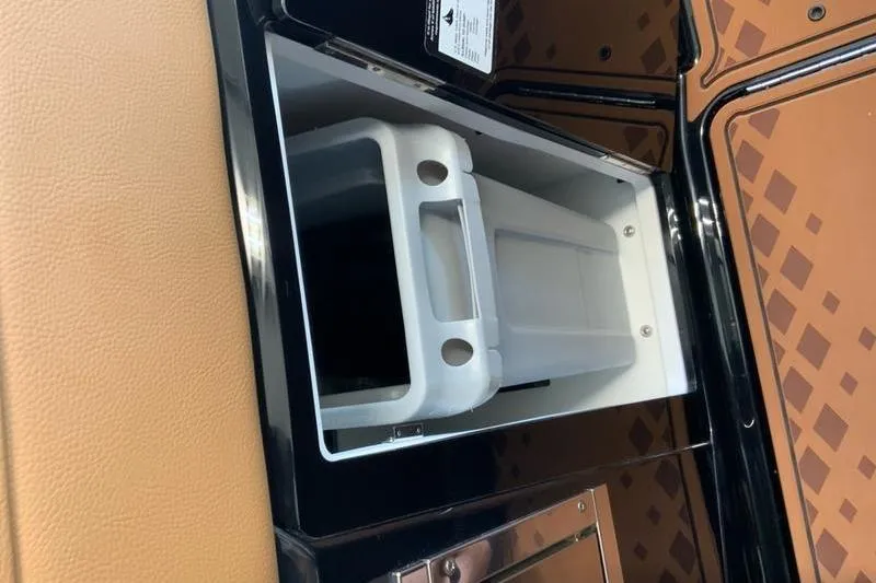 Slide: The Image of 2026 Cobalt R31 Surf boat storage compartment with sleek interior design. - 24