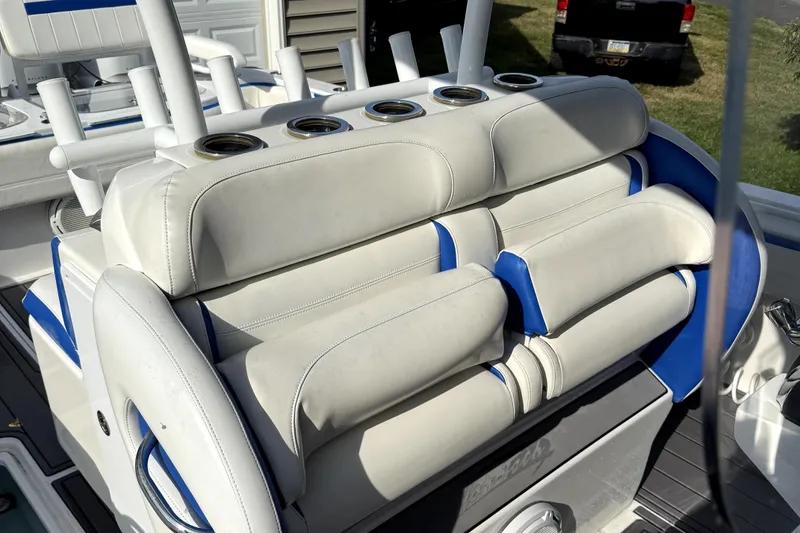 Slide: The Image of 2017 Nor-Tech 392 Superfish boat seating with cup holders, featuring white and blue upholstery. - 11