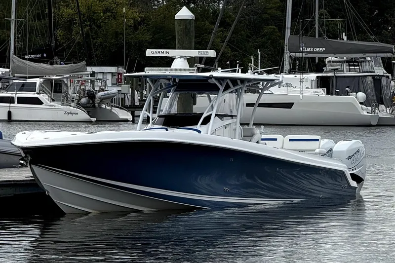 Slide: The Image of 2017 Nor-Tech 392 Superfish boat docked in a marina, surrounded by other vessels. - 2