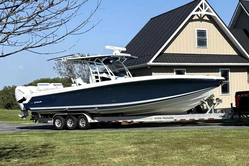 Slide: The Image of 2017 Nor-Tech 392 Superfish boat on trailer, parked near a house. - 3